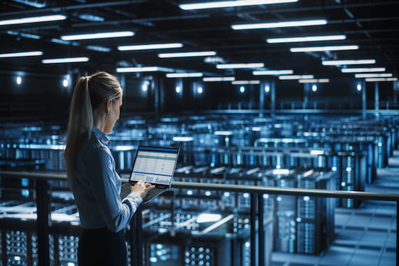 woman in server farm managing cloud infrastructure for business