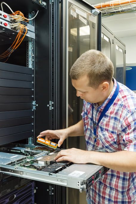 Man servicing a server to maintain cloud services perth